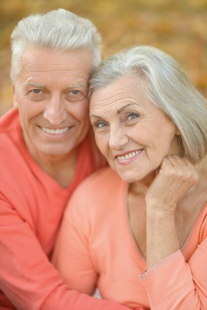 Portrait of a happy senior couple in autumn park