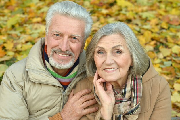 Portrait of a happy senior couple in autumn park