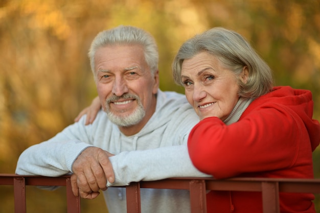 Portrait of a happy senior couple in autumn park