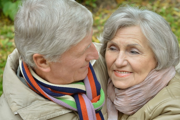 Portrait of a happy senior couple in autumn park