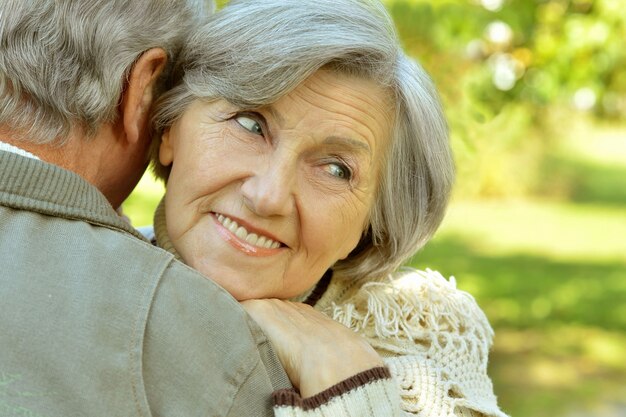 Portrait of a happy senior couple in autumn park