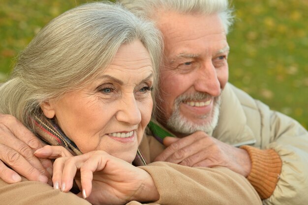 Portrait of a happy senior couple in autumn park