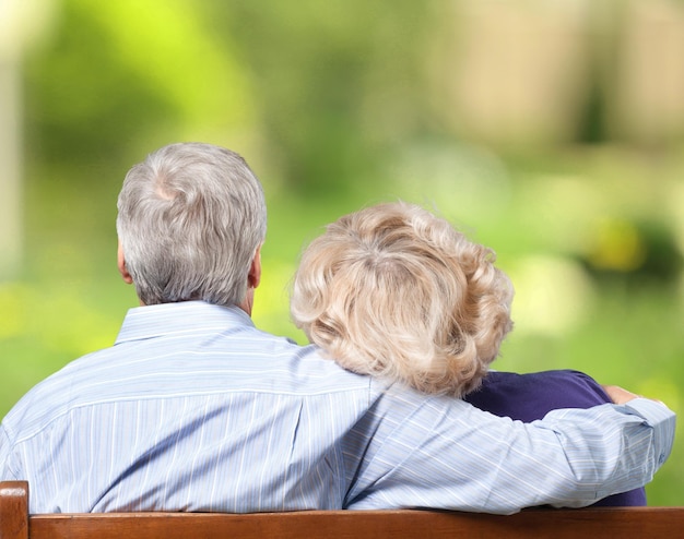 Portrait of happy senior couple on bench