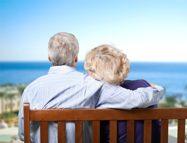 Portrait of happy senior couple on bench