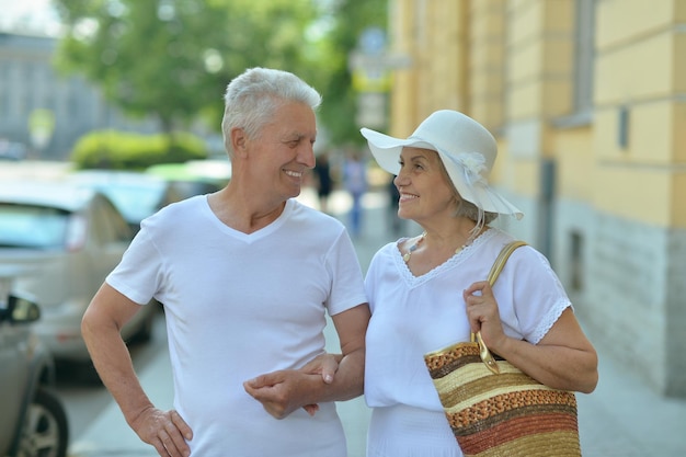 Portrait of happy senior couple on city street