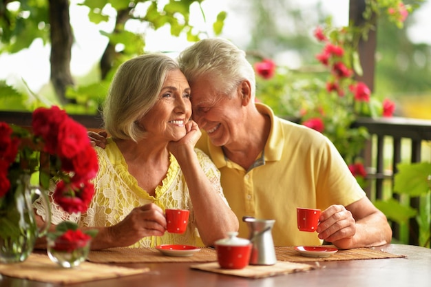 Portrait of happy senior couple drinking coffee