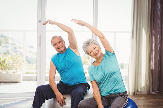 Portrait of happy senior couple exercising