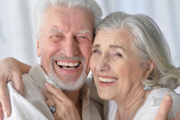 Portrait of a happy senior couple hugging  at home