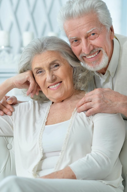 Portrait of a happy senior couple hugging at home