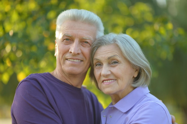 Portrait of a happy senior couple hugging outdoors