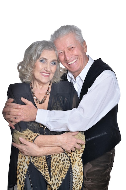 Portrait of happy senior couple hugging on white background
