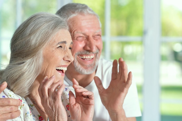 Portrait of a happy senior couple laughing at home