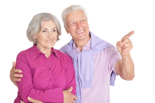 Portrait of a happy senior couple ,man pointing at white background