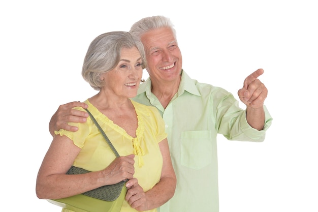 Portrait of a happy senior couple pointing to the right