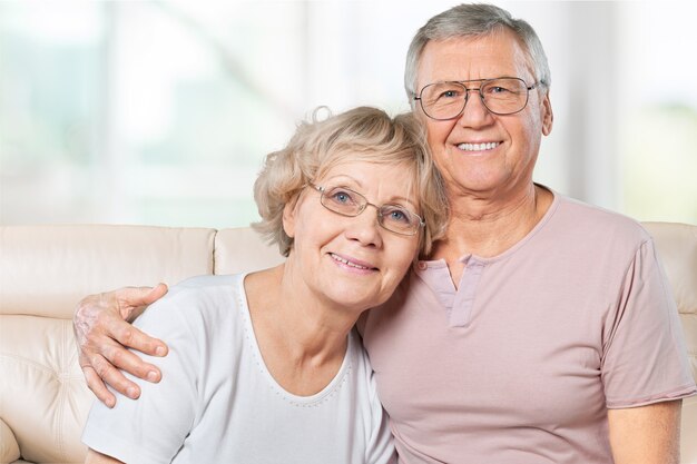 Portrait of happy senior couple smiling at home