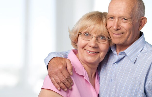 Portrait of happy senior couple smiling at home