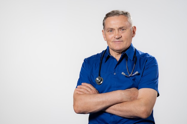 Portrait of happy senior doctor with folded arms isolated on white background confident male doctor