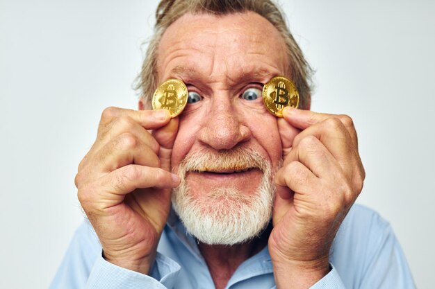 Portrait of happy senior man cryptocurrency bitcoin face close up investment cropped view