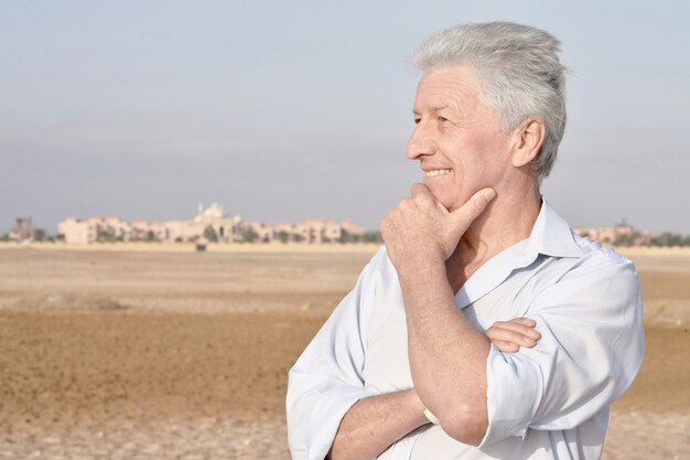 Portrait of a happy senior man in desert