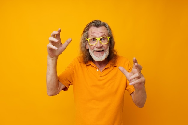 Portrait of happy senior man hand gestures emotions yellow glasses isolated background