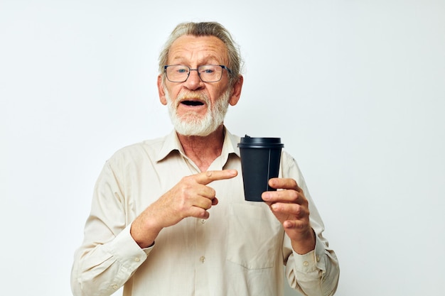 Portrait of happy senior man in a shirt and glasses a black glass cropped view