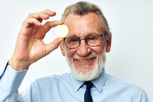 Portrait of happy senior man in a shirt with a tie finance and investments bitcoin unaltered