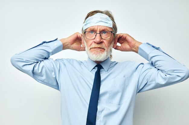 Portrait of happy senior man in shirt with tie medical mask safety light background