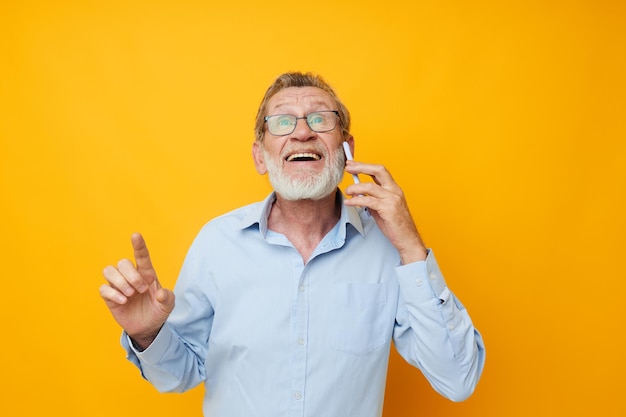 Portrait of happy senior man talking on the phone posing closeup isolated background