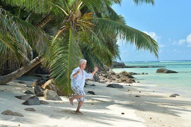 Portrait of a happy senior man at tropical resort