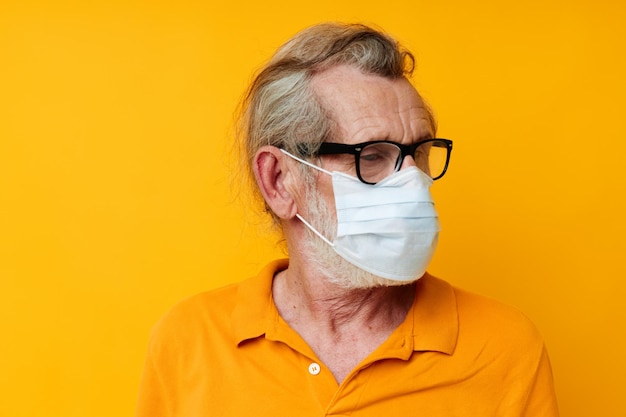 Portrait of happy senior man with glasses face shield safety monochrome shot. High quality photo