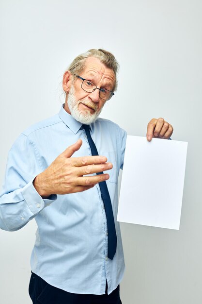 Portrait of happy senior man work office blank sheet of paper light background