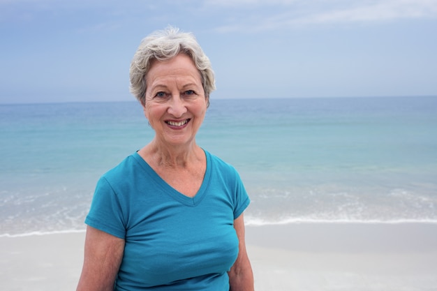 Portrait of happy senior woman on beach