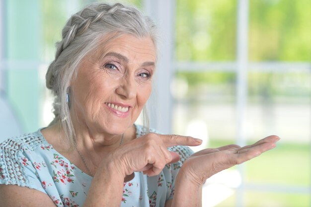 Portrait of happy senior woman posing at home