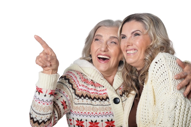 Portrait of happy senior woman showing something on white background