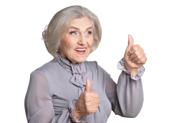 Portrait of happy senior woman showing thumbs up