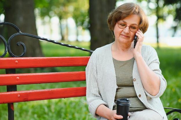 Portrait of a happy Senior woman in summer park