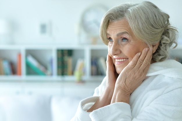 Portrait of happy senior woman with hands on her cheeks