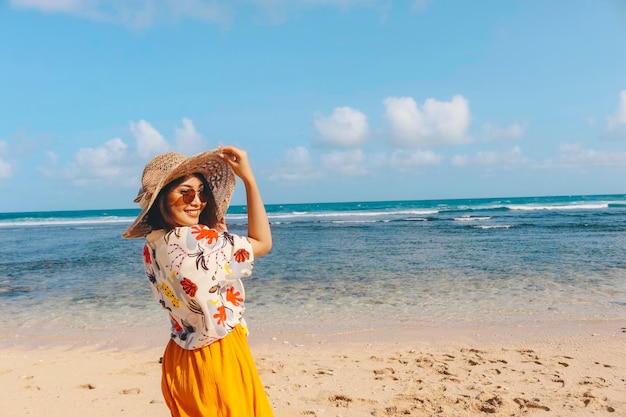 Portrait of happy smiling Asian woman on the beach wear hat