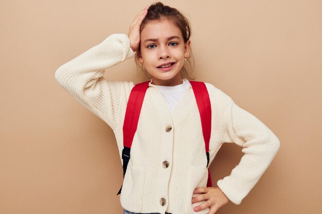 Portrait of happy smiling child girl schoolgirl backpack school childhood unaltered