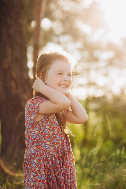 Portrait of happy smiling cute little girl child outdoors in summer day