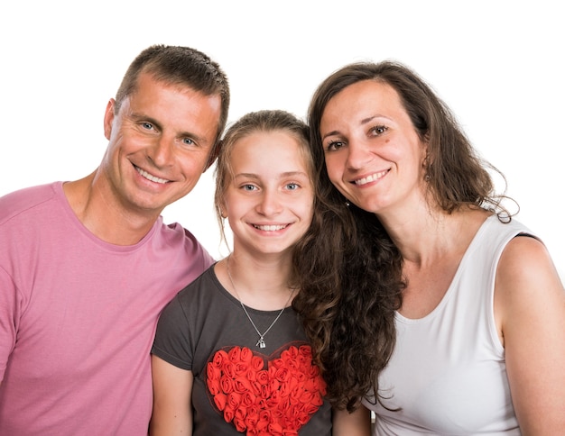 Portrait of happy smiling family posing on a white wall