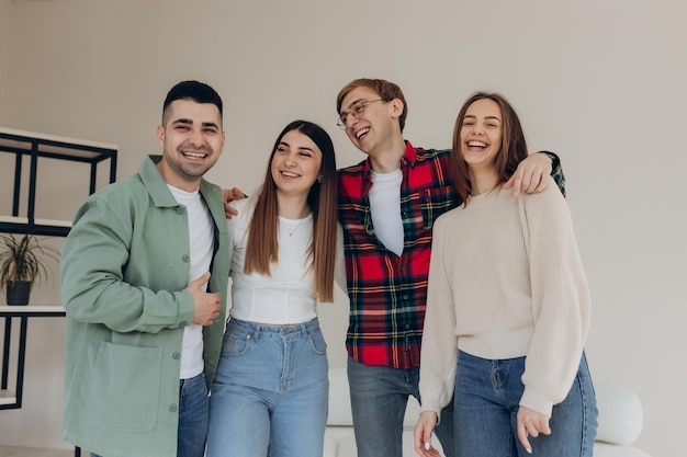 Portrait of happy and smiling friends at home Friends hug and have a good time together