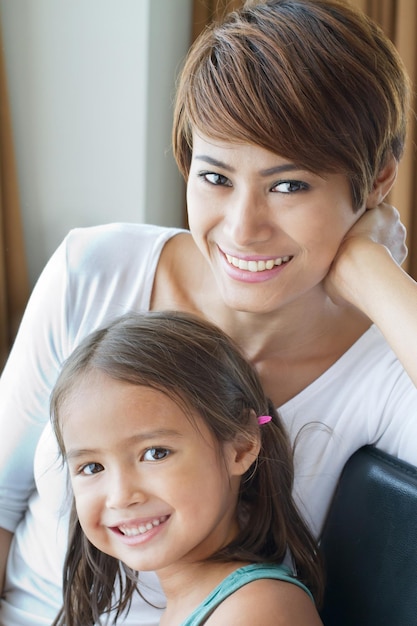 Portrait of happy smiling positive family of mother and daughter