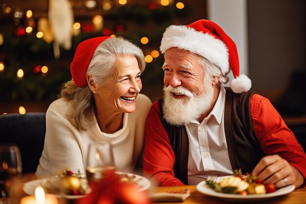 Photo portrait of happy smiling senior couple in santa hats celebrating at home