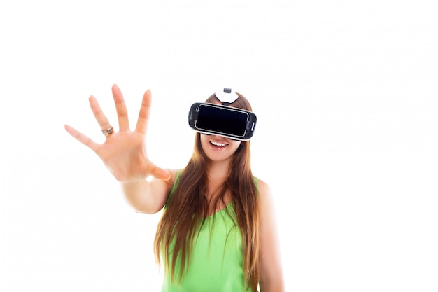 Portrait of happy smiling young beautiful girl getting experience using vr-headset glasses of virtual reality isolated