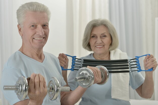 Portrait of a happy sporty senior couple exercising