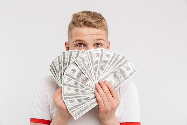 Portrait of a happy teenage boy holding money