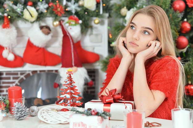 Portrait of happy teenage girl sitting with gift