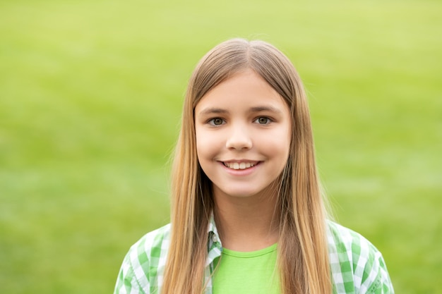 Portrait of happy teenage girl with smiling face blurry outdoors