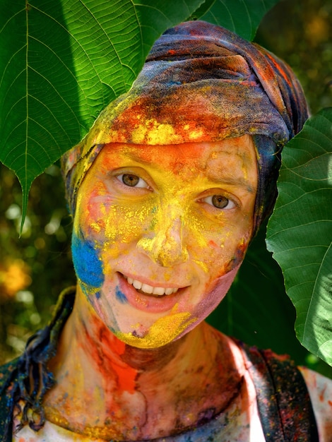 Portrait of a happy woman after holi festival with colorful makeup